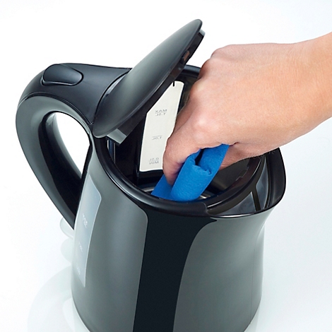 Main nettoyant la bouilloire, couvercle ouvert. Un chiffon bleu à l'intérieur, indicateur de niveau d'eau visible.