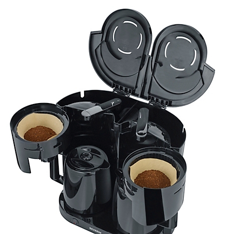 Schwarzer Kaffeeautomat, Filterkörbe mit Kaffeepulver gefüllt, Deckel geöffnet.