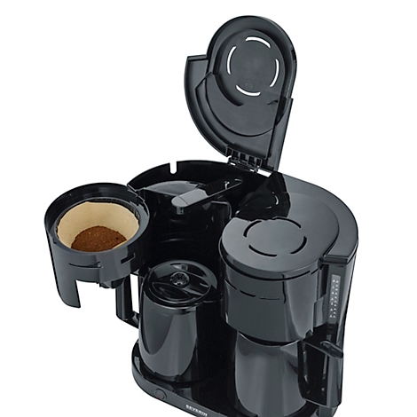 Schwarze Kaffeemaschine, geöffnet. Ein Papierfilter mit Kaffeepulver ist zu sehen.