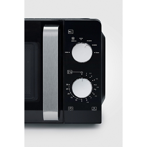 Close-up of a black microwave with a silver handle and control panel. Two rotary knobs control power and time.