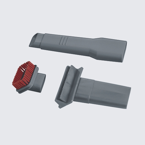 Gray vacuum cleaner attachments; three attachments, one with a red brush.