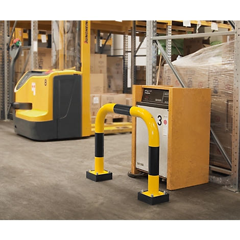 Yellow safety barrier at a warehouse shelf. A yellow forklift in the background.