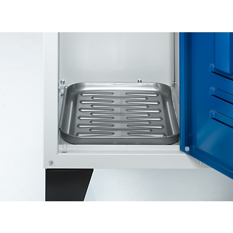 Metal tray with grooves inside a white cabinet, the door is blue.