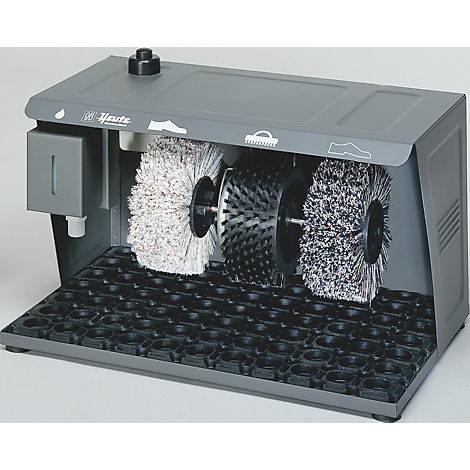 Gray shoe cleaning machine with three rotating brushes and a black collection grid.