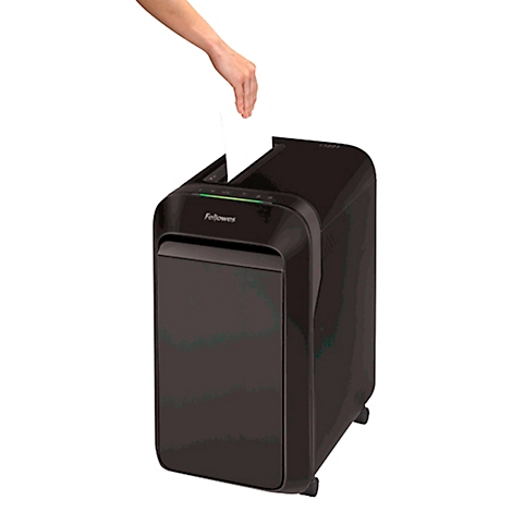 Person dropping paper into a black shredder. The brand name Fellowes is visible on the device.