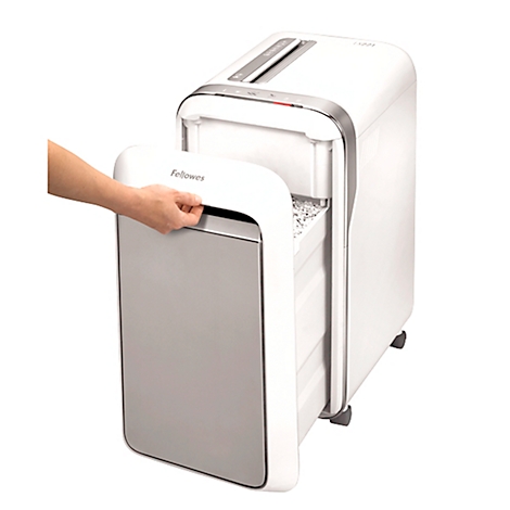 A hand opens the door of a white paper shredder. The housing has silver accents and rollers at the bottom.