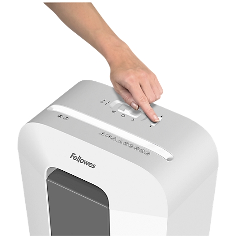 Person presses a button on a white paper shredder. Fellowes logo.
