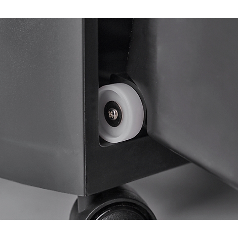 Close-up of a white wheel on a piece of furniture. The wheel is attached to a black bracket.