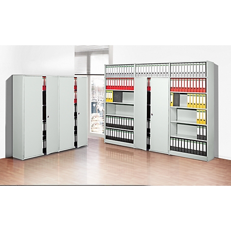 Gray office cabinets, some open, filled with files in different colors, in front of a window.