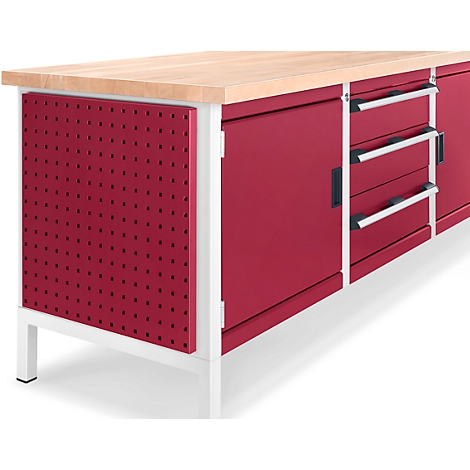 Workbench with red pegboard, drawers and wooden top.