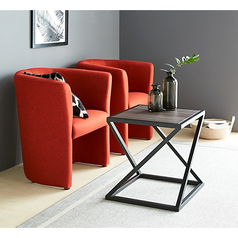 Three red armchairs, a table with a grey top, vases and a decorative basket.