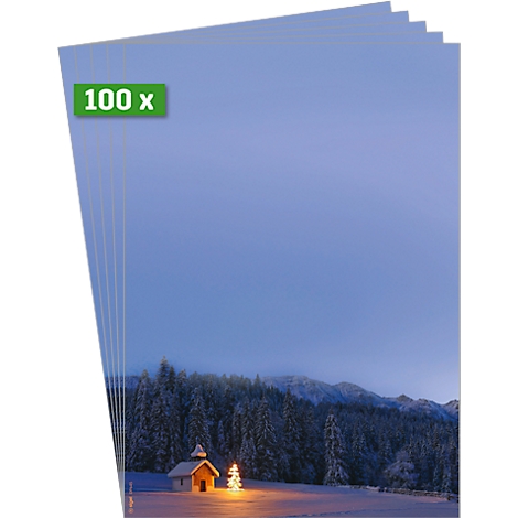 Stapel papier met winterlandschap, tekst '100 x'. Een kapel en kerstboom zijn verlicht.