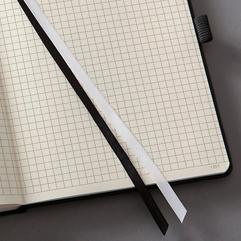 Notebook with graph paper pages and two bookmarks in black and white.
