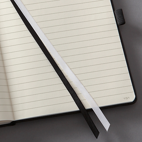 Open notebook with lined pages. Black and white bookmarks mark pages. '151' is printed on the corner.