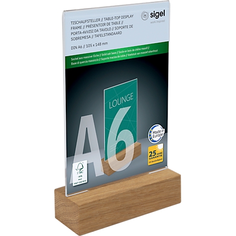 Wooden table display with an inserted card, green with lettering.