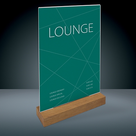 Menu card with green background and white text. Inscription: LOUNGE. Wooden base.
