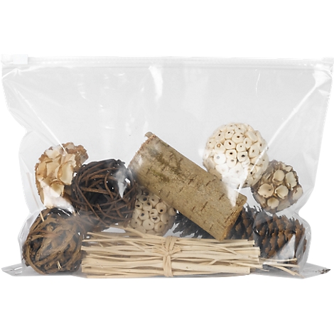A bag with decorative materials. It contains balls, pieces of bark, and a bundle of straw.
