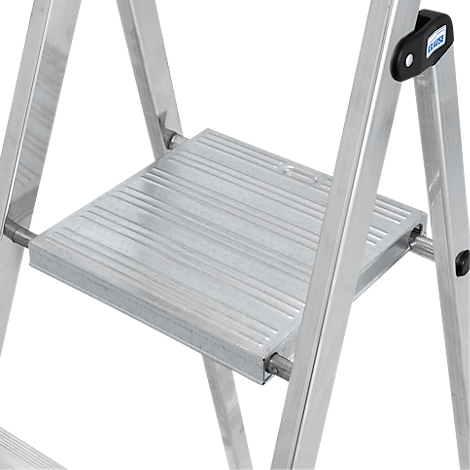 Close-up of a silver step ladder. The ribbed platform is in focus, along with the sturdy metal rungs.