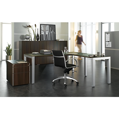 Modern office with desk, chair, and cabinet. A person is entering the room. The focus is on the furniture.