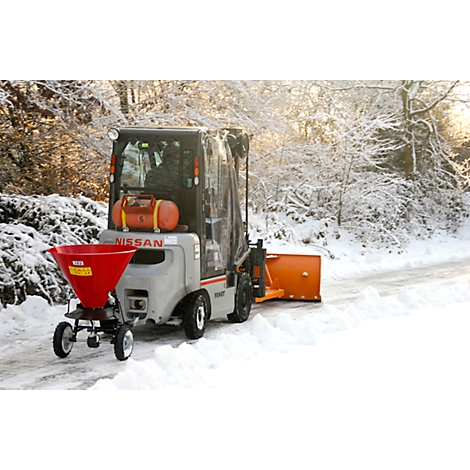 Gray Nissan snowplow with red salt spreader and orange plow on a snow-covered road.