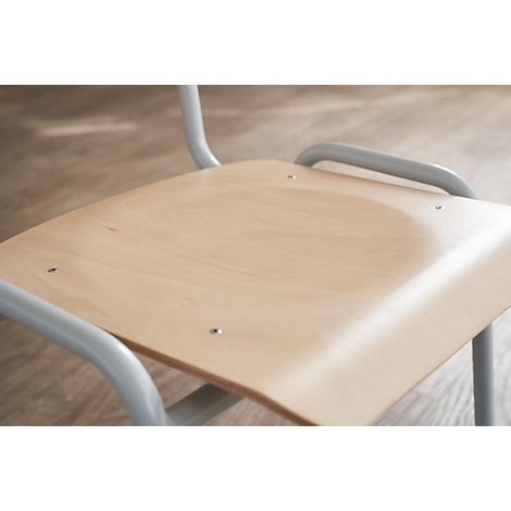 Close-up of a chair. Wood-colored seat, gray metal frame.