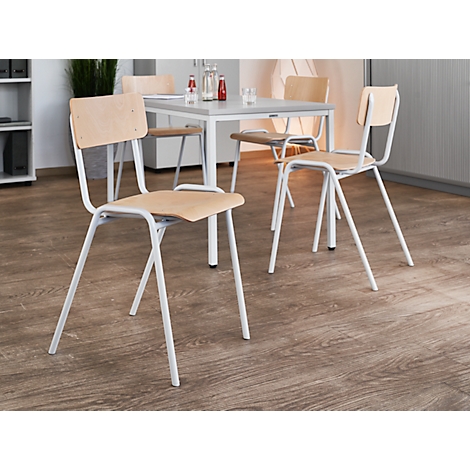 Several white chairs with light wooden seats and backs stand around a table.