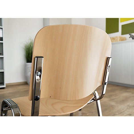 Close-up of a chair showing the wooden backrest and metal armrests. Other furnishings are in the background.