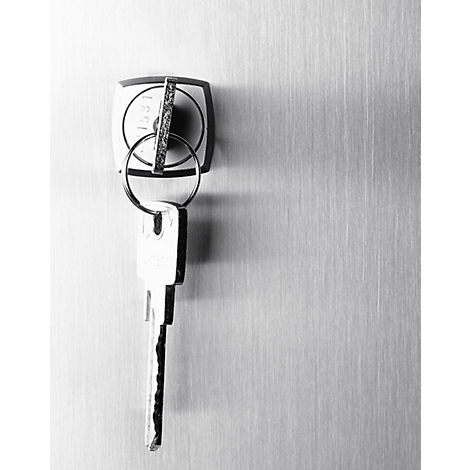 Keys in a lock. A key ring is hanging down. Grey background with vertical lines.
