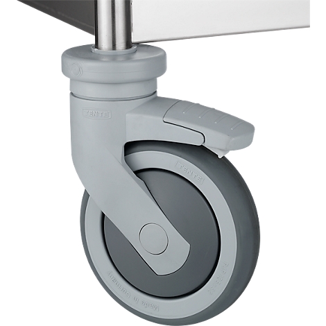 Close-up of a gray caster wheel with brake lever and rubber wheel. The lever is engaged.