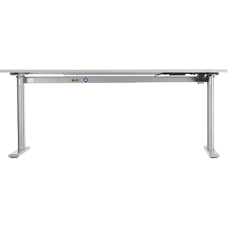 A height-adjustable desk in light gray. The frame is made of metal, the table top is light. The height is variable.