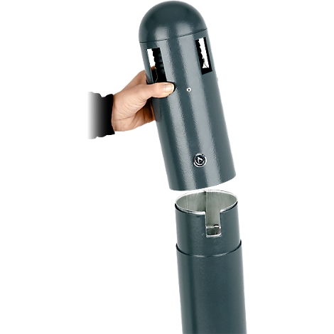 Person holding a green, cylindrical object that is being separated into two parts. The top part has two openings.