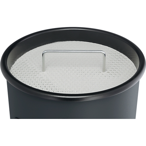 Close-up of a round container with a white filter insert and silver handle.
