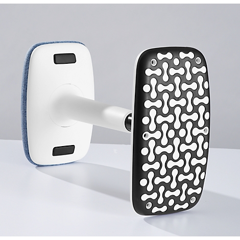 A white device with two rectangular ends. One end has a blue fabric, the other a black surface with a white pattern.