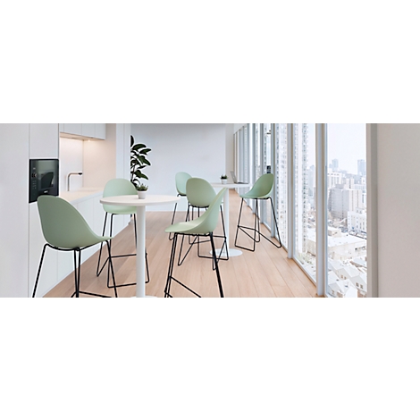 A bright room with bar stools and a table in front of a panoramic window. The chairs are light green, the table white.