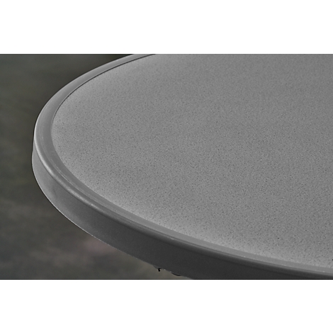 Close-up of part of a gray round table with visible grain and dark edge.