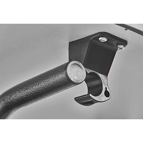 Close-up of a bracket with a metal bar. The bracket is attached to a gray surface, metal bar in the bracket.