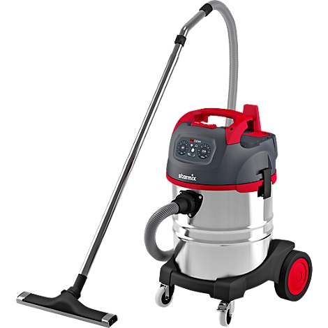 Vacuum cleaner with silver tank, red handle and black floor nozzle. On wheels, black base.