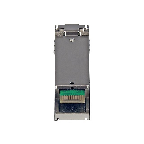 Ein rechteckiges, silberfarbenes elektronisches Gerät mit einem grünen Steckverbinder unten. Auf hellem Hintergrund.
