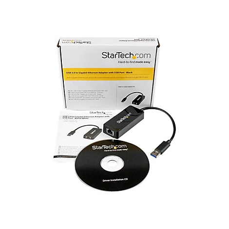 Un adaptateur USB vers Gigabit Ethernet noir avec emballage, CD et documentation. L'emballage indique StarTech.com.
