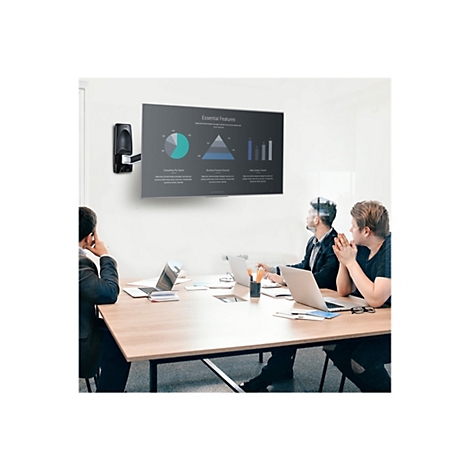 Eine Besprechung in einem Büro, mit Personen, die vor Laptops sitzen und einen Bildschirm mit Diagrammen betrachten. Auf dem Bildschirm sind verschiedene Diagramme dargestellt.