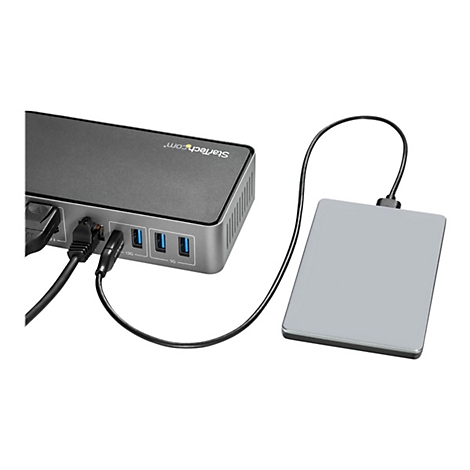 Un hub USB gris avec un disque dur connectÃ©. Des cÃ¢bles relient les deux appareils, le hub possÃ¨de des ports USB.