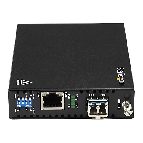 Ein schwarzer Netzwerk-Medienkonverter mit Anschlüssen, Anzeigen und StarTech.com Logo. Beschriftung: 1000TS.