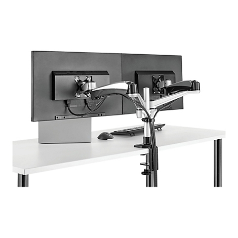 Un support de moniteur pour deux Ã©crans sur un bureau blanc. Le dos des moniteurs est visible, ainsi que le support et les cÃ¢bles.