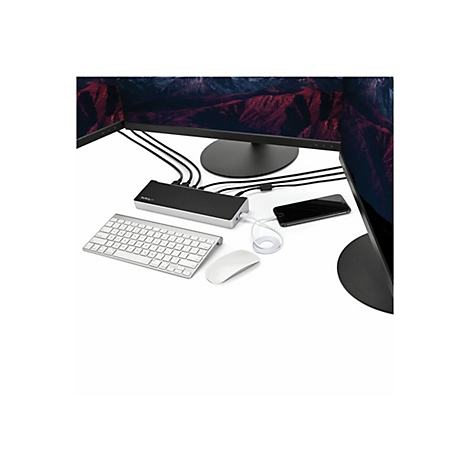 Configuration de bureau avec moniteur, station d'accueil, clavier, souris et smartphone.