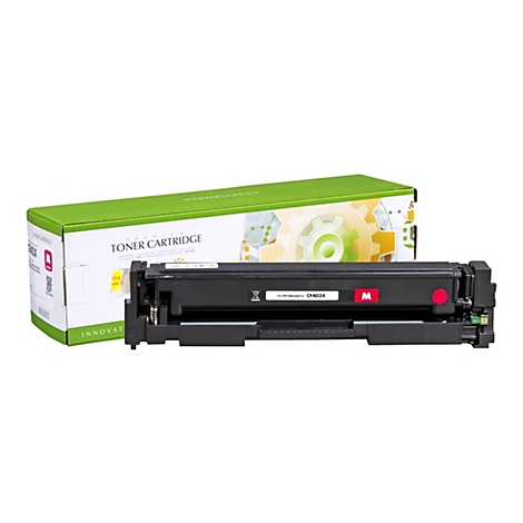 Tonerkartusche neben grÃ¼ner Schachtel. Schwarze Kartusche, rotes M-Logo, Box mit TONER CARTRIDGE.