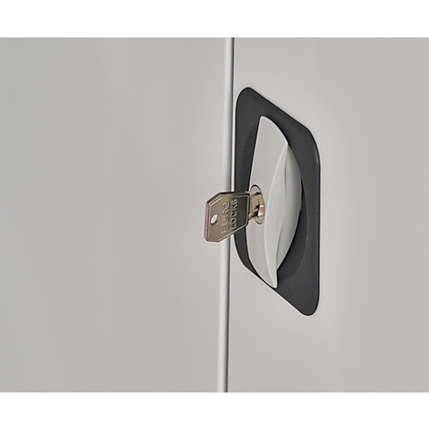Close-up of a cabinet handle with a key inserted in the lock. The key reads "Ferco Locks".