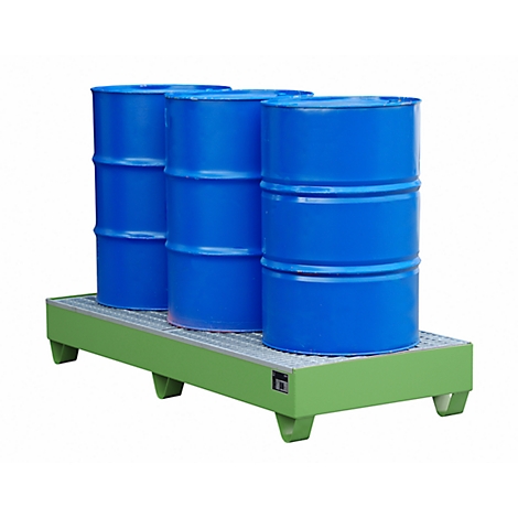 Three blue barrels stand on a green spill containment. The barrels are made of metal. The spill containment has a grid pattern.