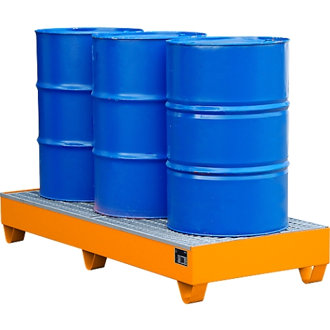 Three blue barrels stand on an orange spill containment.