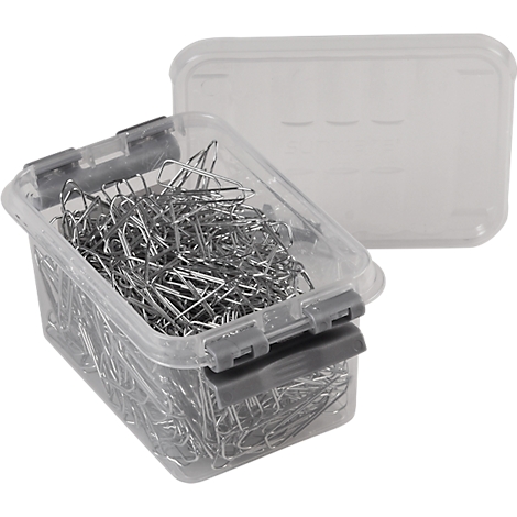 A clear plastic box filled with many metal paper clips, the lid is next to it.