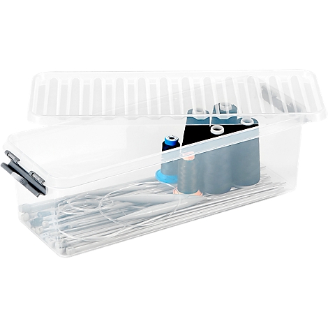 Transparent plastic box containing knitting needles, spools of yarn and accessories.